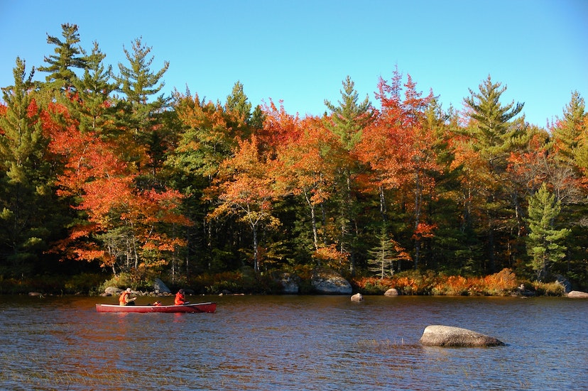 Canoes enjoying the fall scenery of Kejimkujik National Park. Established in 1967 Kejimkujik National Park is located in Southwestern Nova Scotia, Canada. With its many lakes and beautiful natural scenery, it popular with canoeing and backcountry camping.